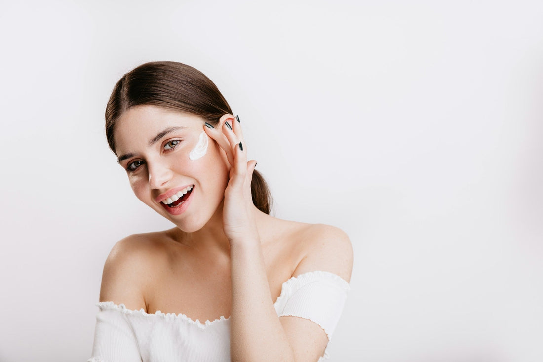 woman applying skin product to her face