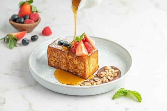 a piece of cake is being drizzled with honey